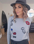 Pull gris écussons