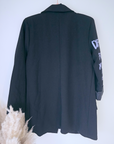 Veste noire à tags parmes