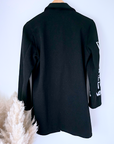 Manteau noir à tag