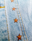 Veste en jean à inscriptions en perles