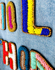 Veste en jean à inscriptions en perles