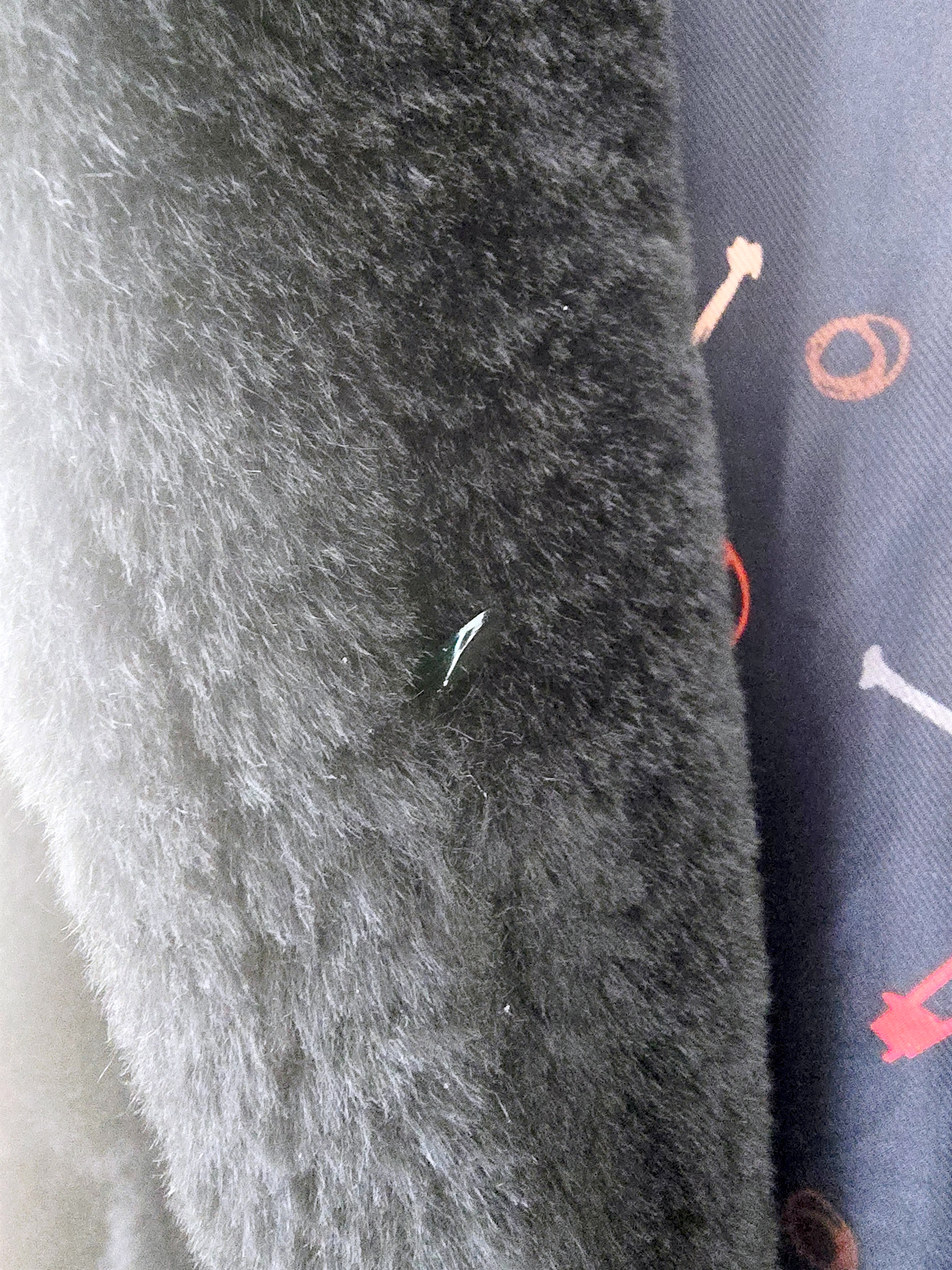 Manteau fausse fourrure noire à capuche sans manche.