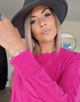 Pull torsadé fuchsia